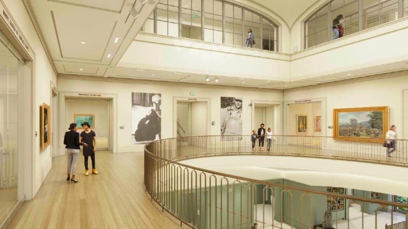 a multi-level view shows guests and art work in an art museum